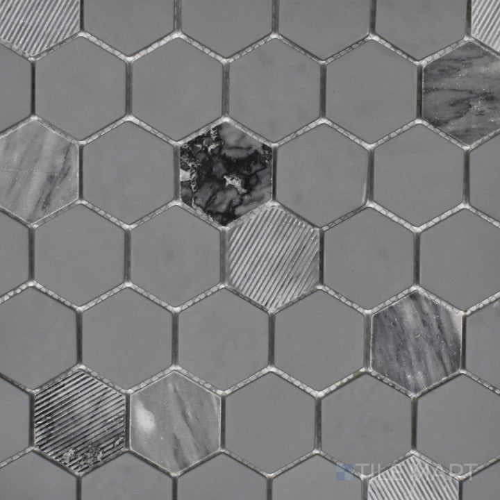 An overhead shot of the Rockart Gray Hexagon mosaic emphasizes its mix of matte and polished granite with recycled glass, creating a structured and contemporary hexagonal layout.