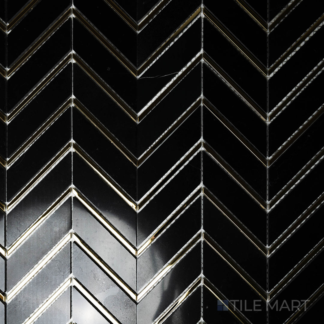 Captured from above, the Rockart Nero Metal Arrow Polished mosaic features deep black marble with sharp metallic arrow accents, making a bold statement in any setting.