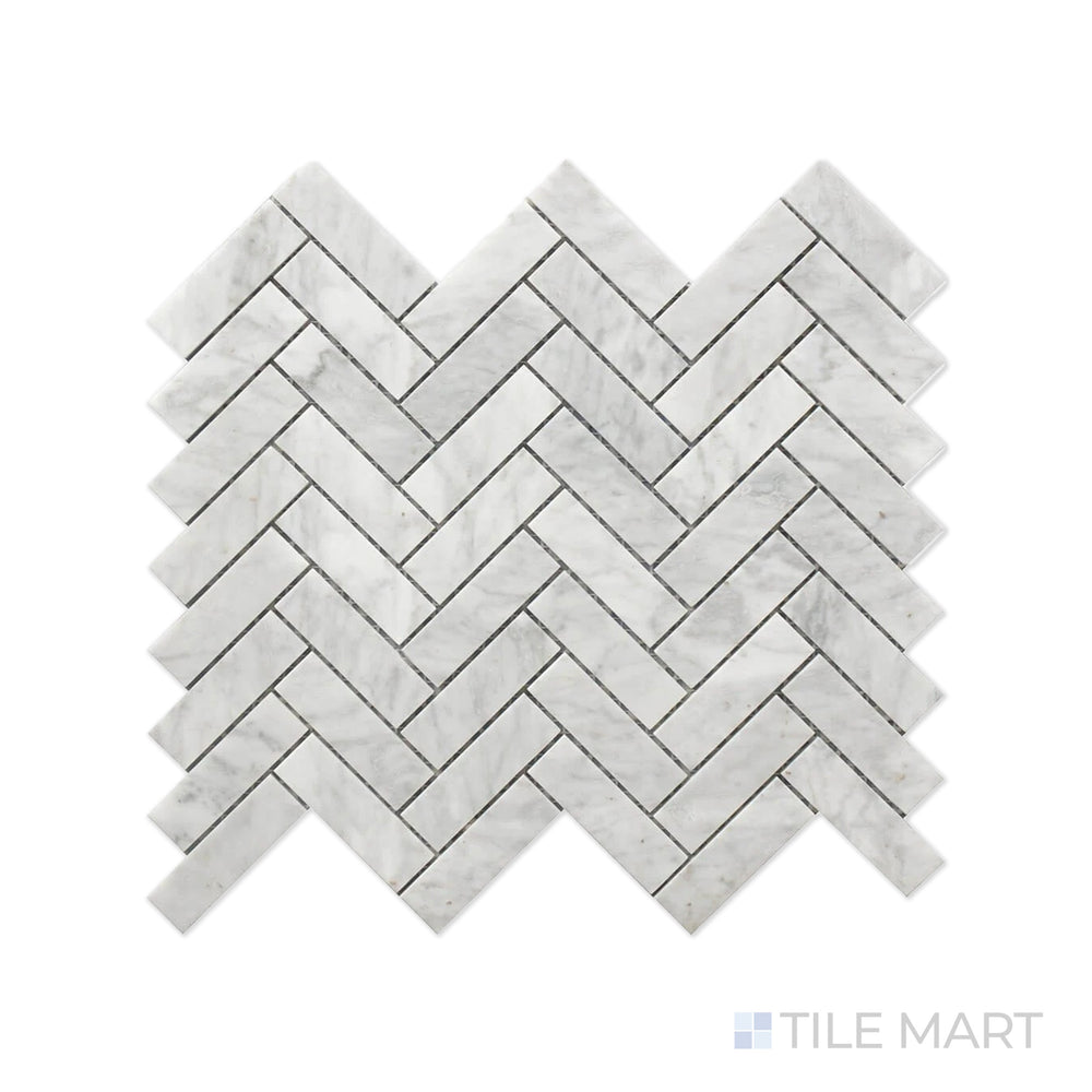 Close-up of Rockart Carrara Herringbone Polished Marble Mosaic, highlighting its classic herringbone pattern with soft white Carrara marble and natural veining.