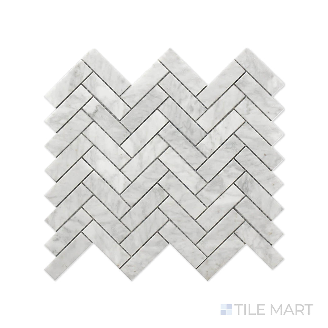 Close-up of Rockart Carrara Herringbone Polished Marble Mosaic, highlighting its classic herringbone pattern with soft white Carrara marble and natural veining.