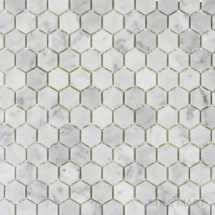 Captured from above, the Rockart Carrara Marble 1" Hexagon Mosaic features a polished hexagonal pattern with rich Carrara veining, adding geometric elegance to any space.