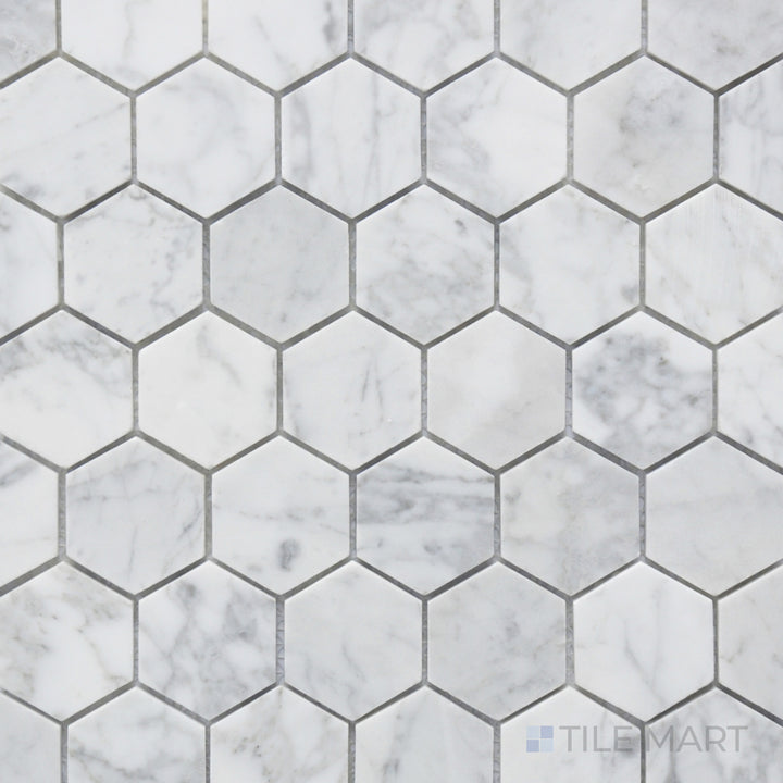 A high-angle view of the Rockart Carrara Marble 2" Hexagon Mosaic highlights its refined white Carrara marble in a larger hexagonal format, offering a contemporary yet classic look.