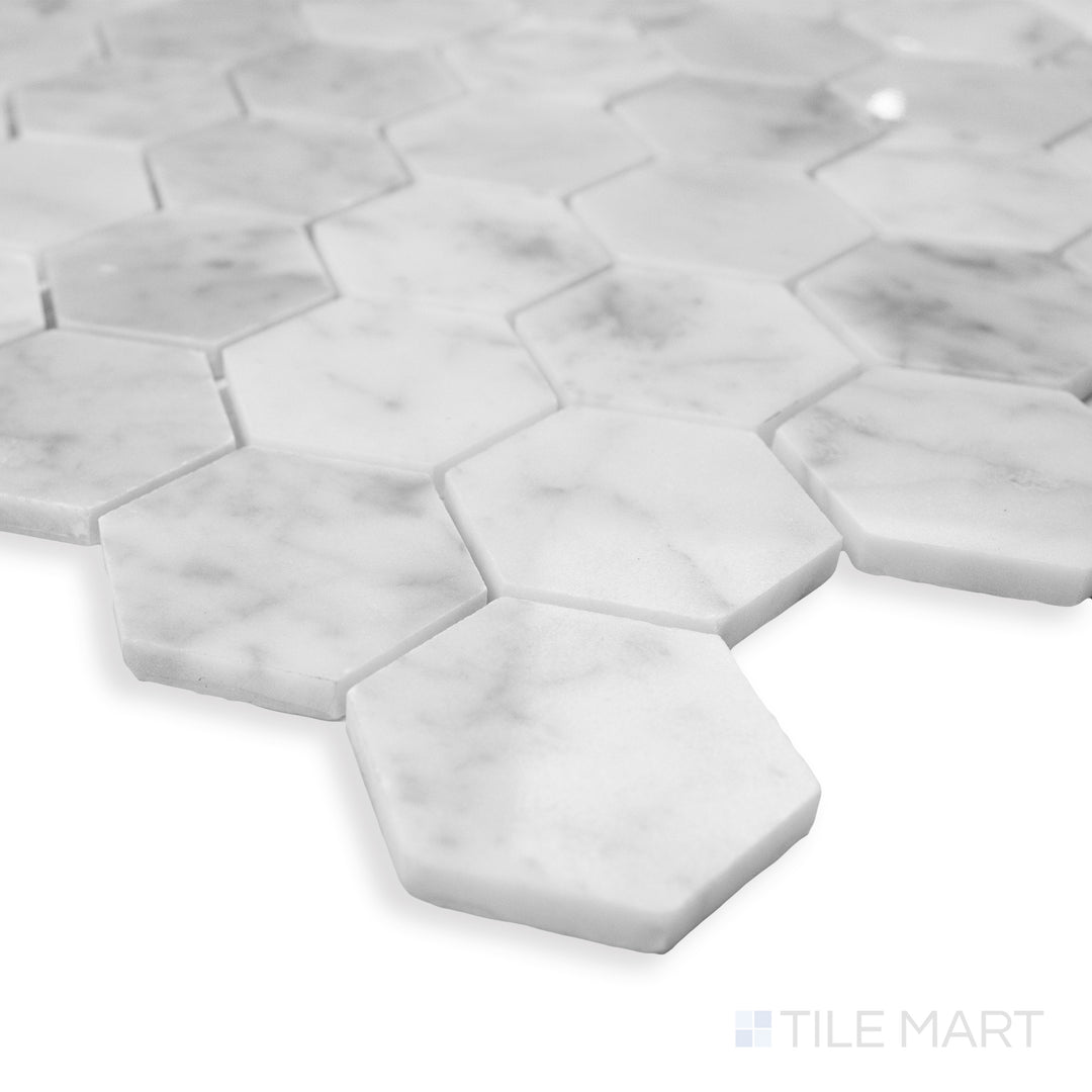 A modern corner perspective of Rockart Carrara Marble 2" Hexagon mosaic, featuring a larger hexagonal pattern and refined white marble veining.
