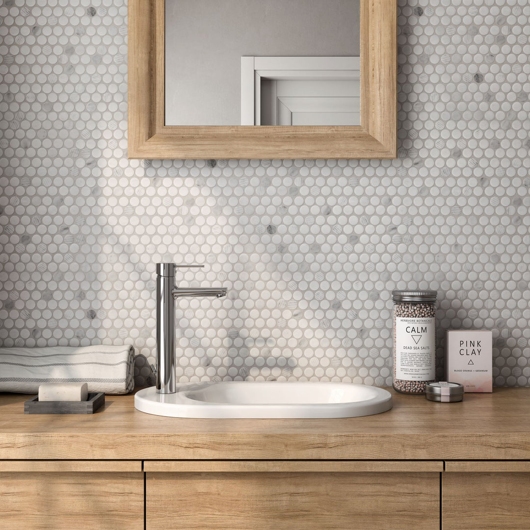 A blend of sophistication and texture, Rockart Carrara marble penny round mosaic adds intricate detailing to walls and floors.