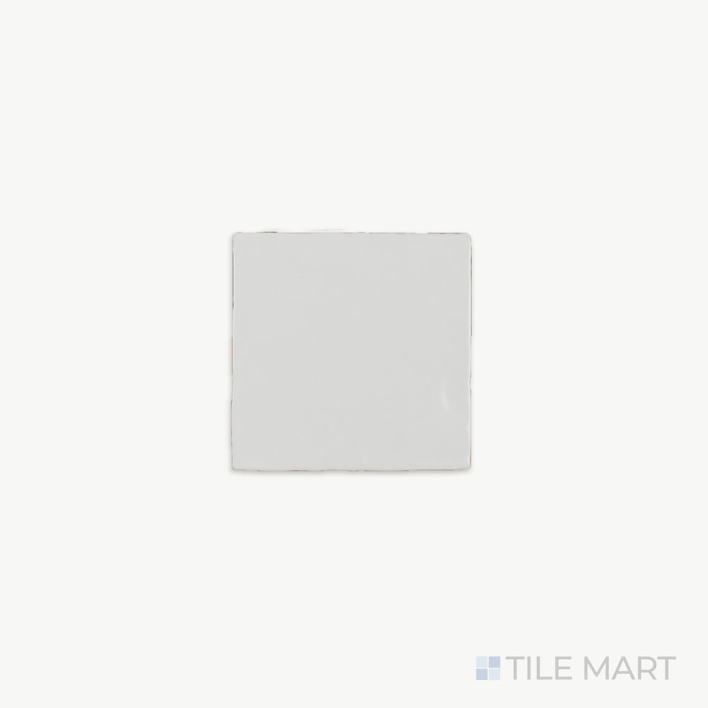 A close-up of St. Tropez Blanco 5X5 Bright Ceramic, showcasing its luminous white finish and smooth glazed surface that enhances light reflection.