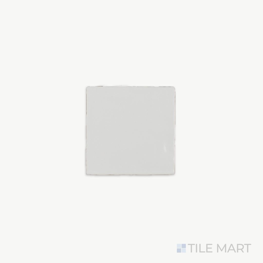 A close-up of St. Tropez Blanco 5X5 Bright Ceramic, showcasing its luminous white finish and smooth glazed surface that enhances light reflection.