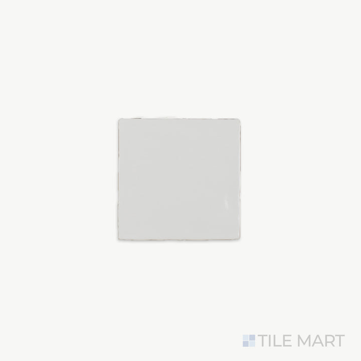 A close-up of St. Tropez Blanco 5X5 Bright Ceramic, showcasing its luminous white finish and smooth glazed surface that enhances light reflection.