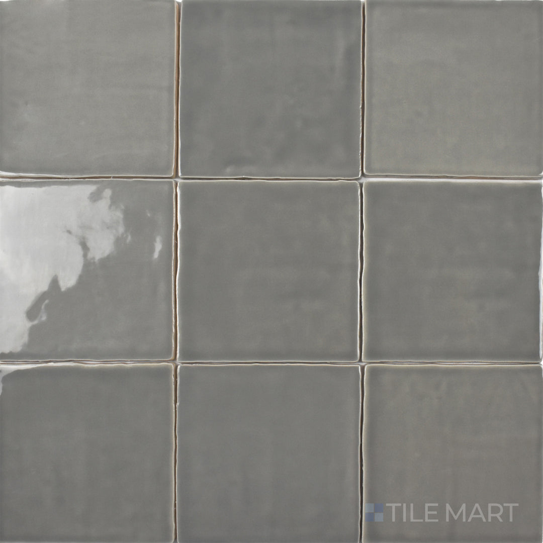 An overhead view of the St. Tropez Gris 5x5 inch bright ceramic tile highlights its smooth gray tone and glossy surface, creating a sleek and modern aesthetic.