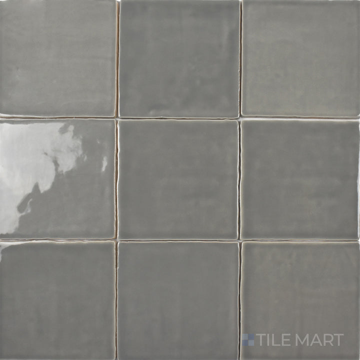 An overhead view of the St. Tropez Gris 5x5 inch bright ceramic tile highlights its smooth gray tone and glossy surface, creating a sleek and modern aesthetic.