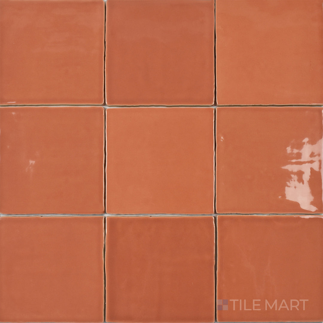 This bird’s-eye perspective of the St. Tropez Coral 5x5 inch bright ceramic tile showcases its warm coral hue and reflective glaze, bringing a vibrant and inviting feel to interiors.