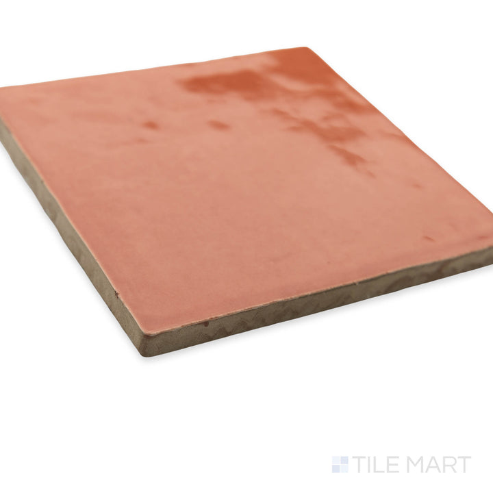 St. Tropez Coral 5x5 bright ceramic tile captured in a stylish corner perspective, highlighting its warm coral hue and glossy sheen.