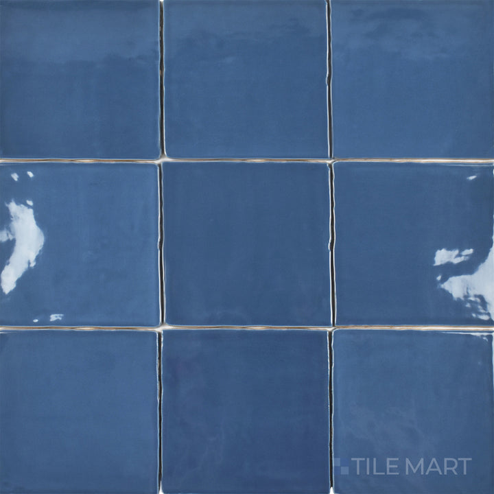An overhead shot of the St. Tropez Azul 5x5 inch bright ceramic tile emphasizes its bold blue tone with a glossy finish, perfect for creating a statement design.