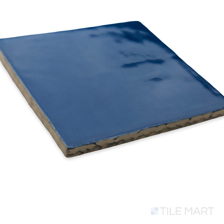 A fresh and bold corner shot of St. Tropez Azul 5x5 bright ceramic tile, showcasing its vibrant blue shade and reflective glazed finish.