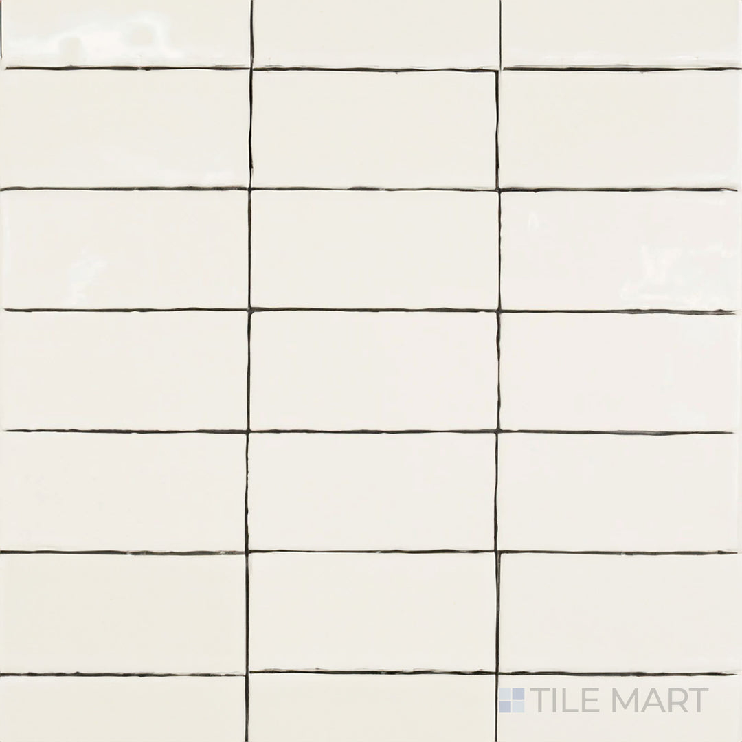 Captured from above, the St. Tropez Blanco 2.5x5 inch bright ceramic tile features a clean white color with a high-gloss sheen, adding depth and elegance to any space.
