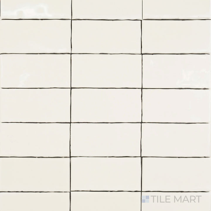 Captured from above, the St. Tropez Blanco 2.5x5 inch bright ceramic tile features a clean white color with a high-gloss sheen, adding depth and elegance to any space.