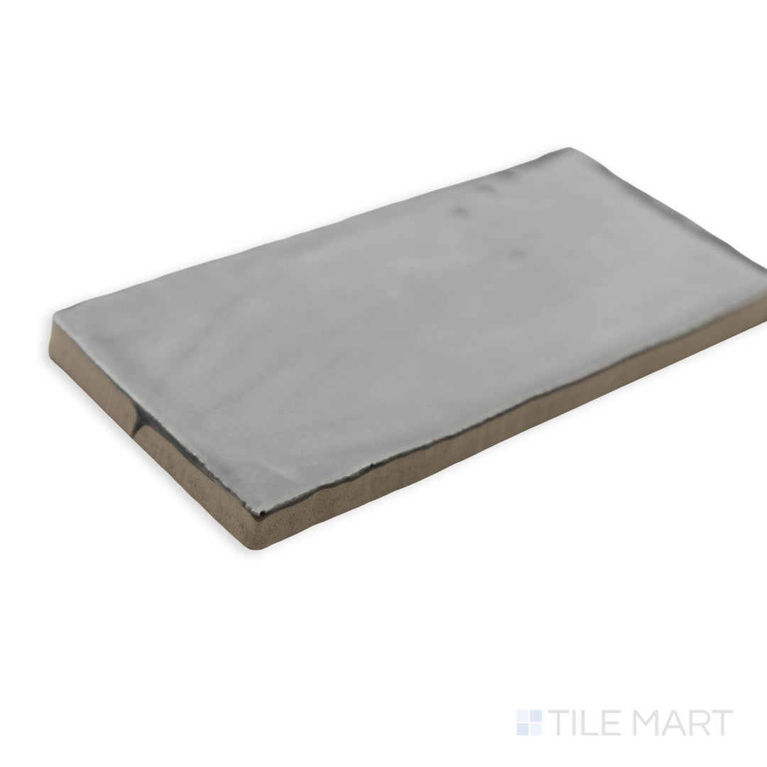 St. Tropez Gris 2.5x5 bright ceramic tile captured in a corner shot, highlighting its elegant gray tone and smooth polished surface.