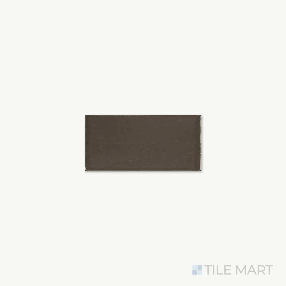 Close-up of St. Tropez Bronce 2.5X5 Bright Ceramic, capturing its warm bronze shade and glossy ceramic surface that adds a touch of depth.