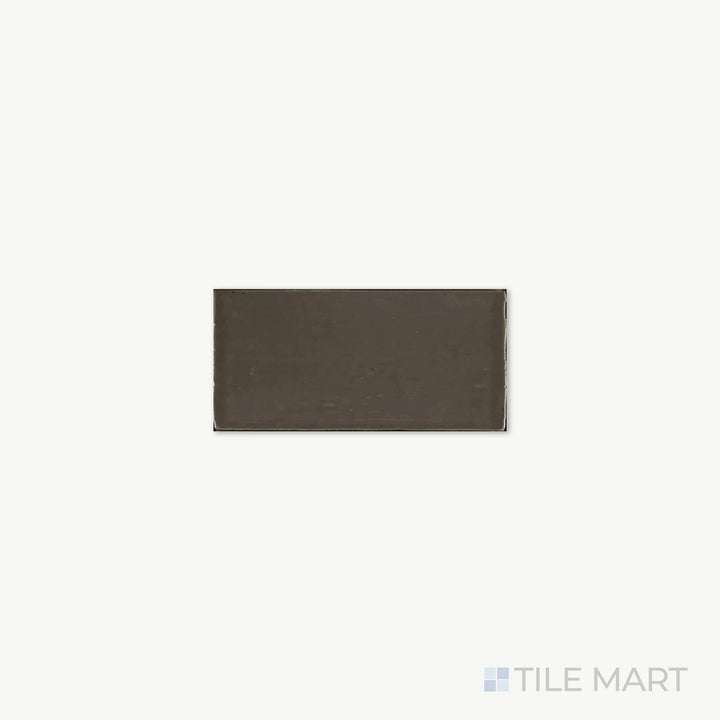 Close-up of St. Tropez Bronce 2.5X5 Bright Ceramic, capturing its warm bronze shade and glossy ceramic surface that adds a touch of depth.