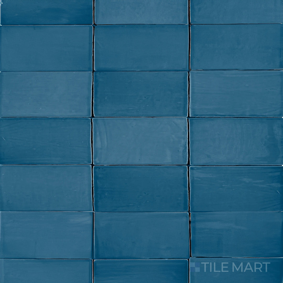 An overhead view of the St. Tropez Azul 2.5x5 inch bright ceramic tile highlights its bold blue tone and glossy sheen, creating a striking and refreshing aesthetic.