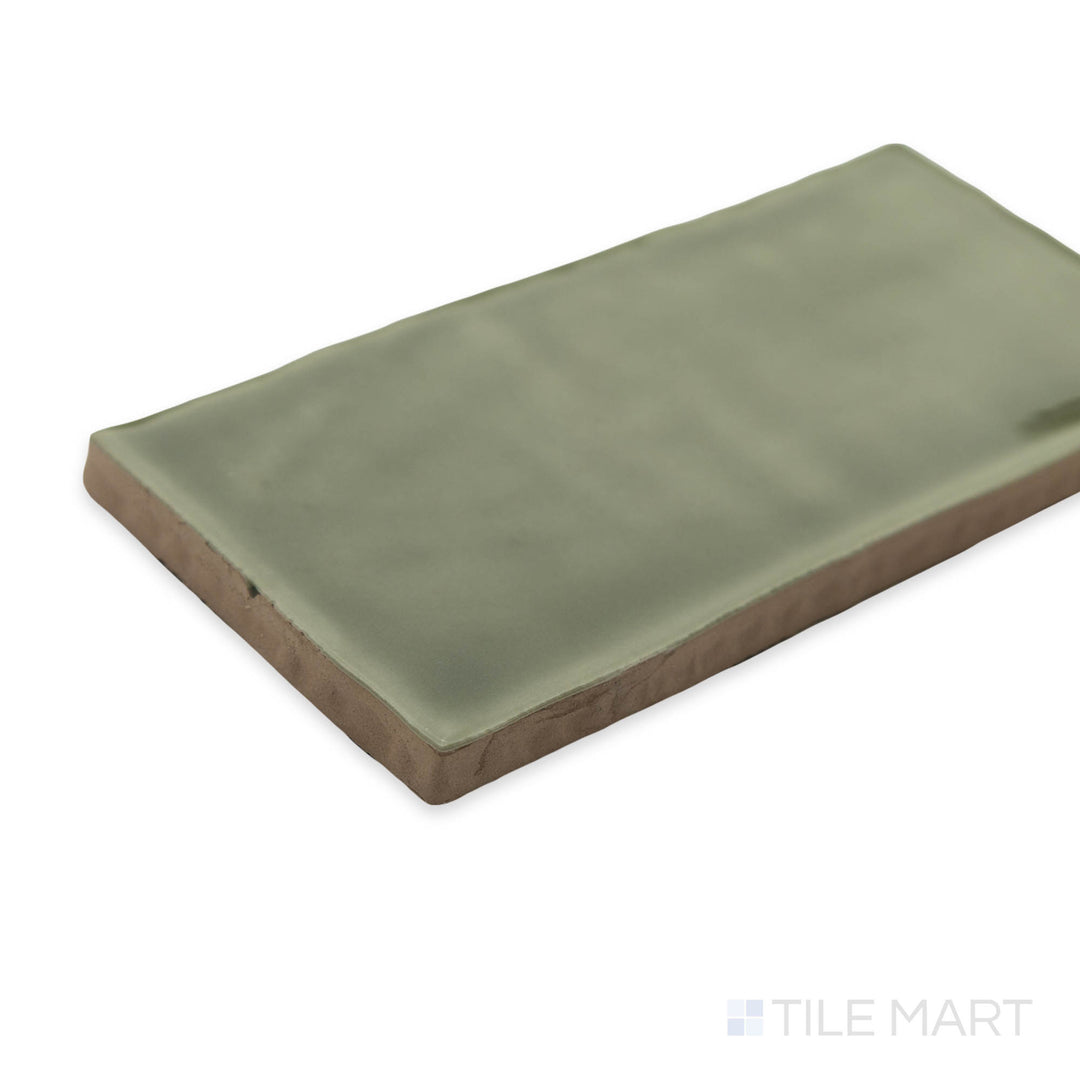 St. Tropez Verde 2.5x5 bright ceramic tile captured in a fresh corner perspective, showcasing its lively green shade and smooth polished finish.