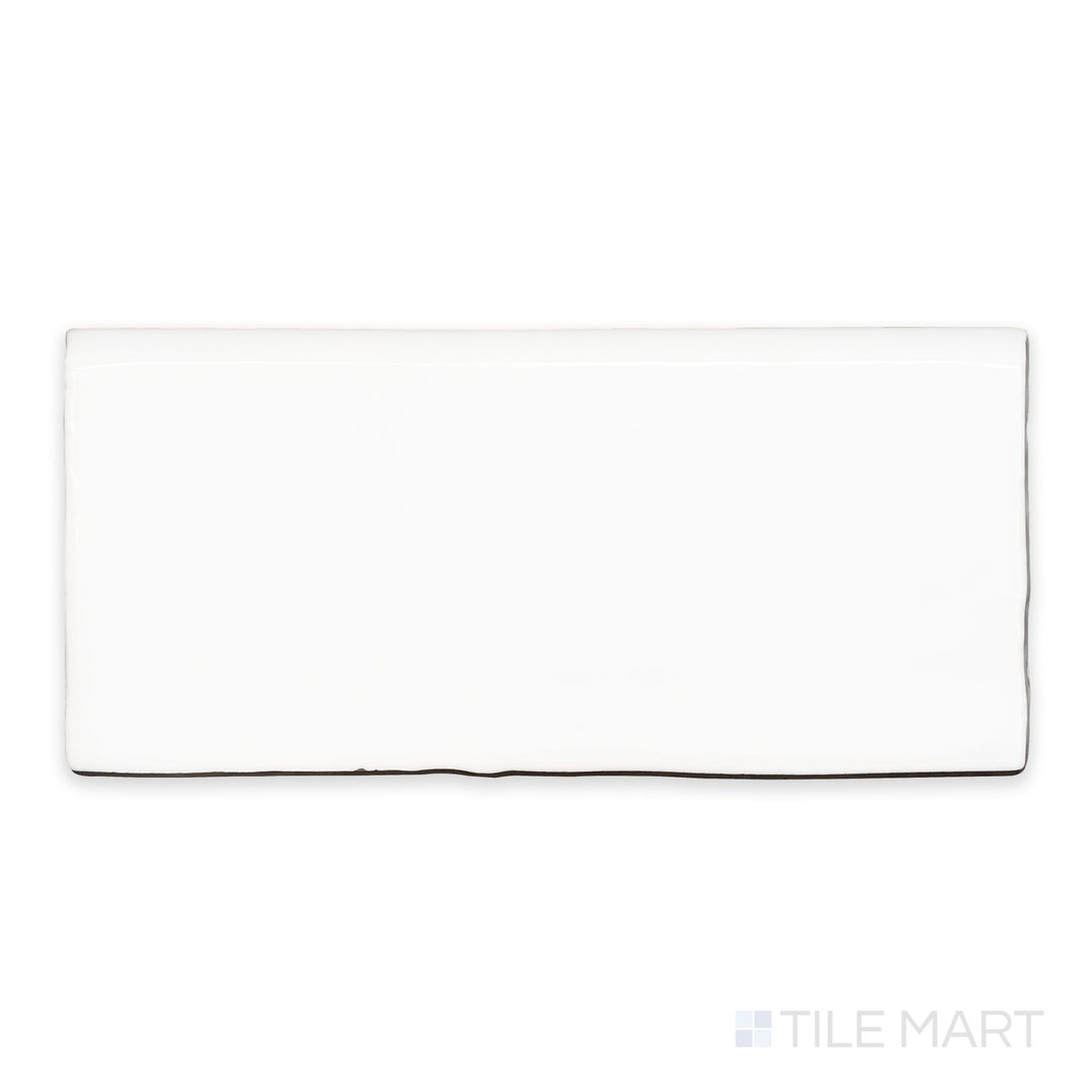 A flat-lay shot of St. Tropez Blanco 2.5x5 bright ceramic bullnose, highlighting its bright white tone and smooth, polished surface.