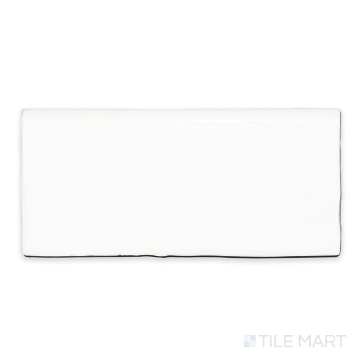 A flat-lay shot of St. Tropez Blanco 2.5x5 bright ceramic bullnose, highlighting its bright white tone and smooth, polished surface.
