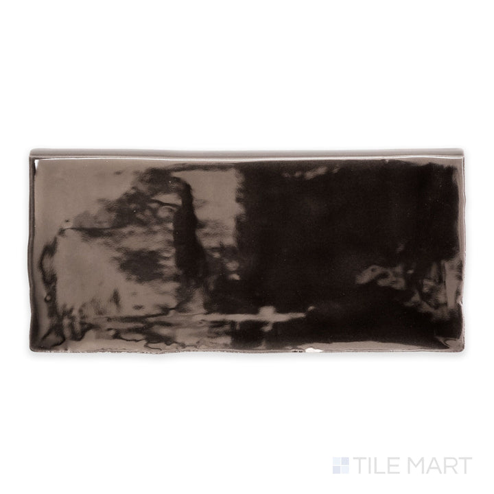 A detailed top-down view of St. Tropez Bronce 2.5x5 bright ceramic bullnose, emphasizing its warm bronze shade and sleek, glossy texture.