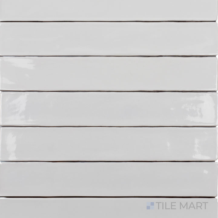 This top-down shot of the Zellige White 2x16 inch bright ceramic tile showcases its crisp white tone with a high-gloss glaze, offering a clean and timeless look.