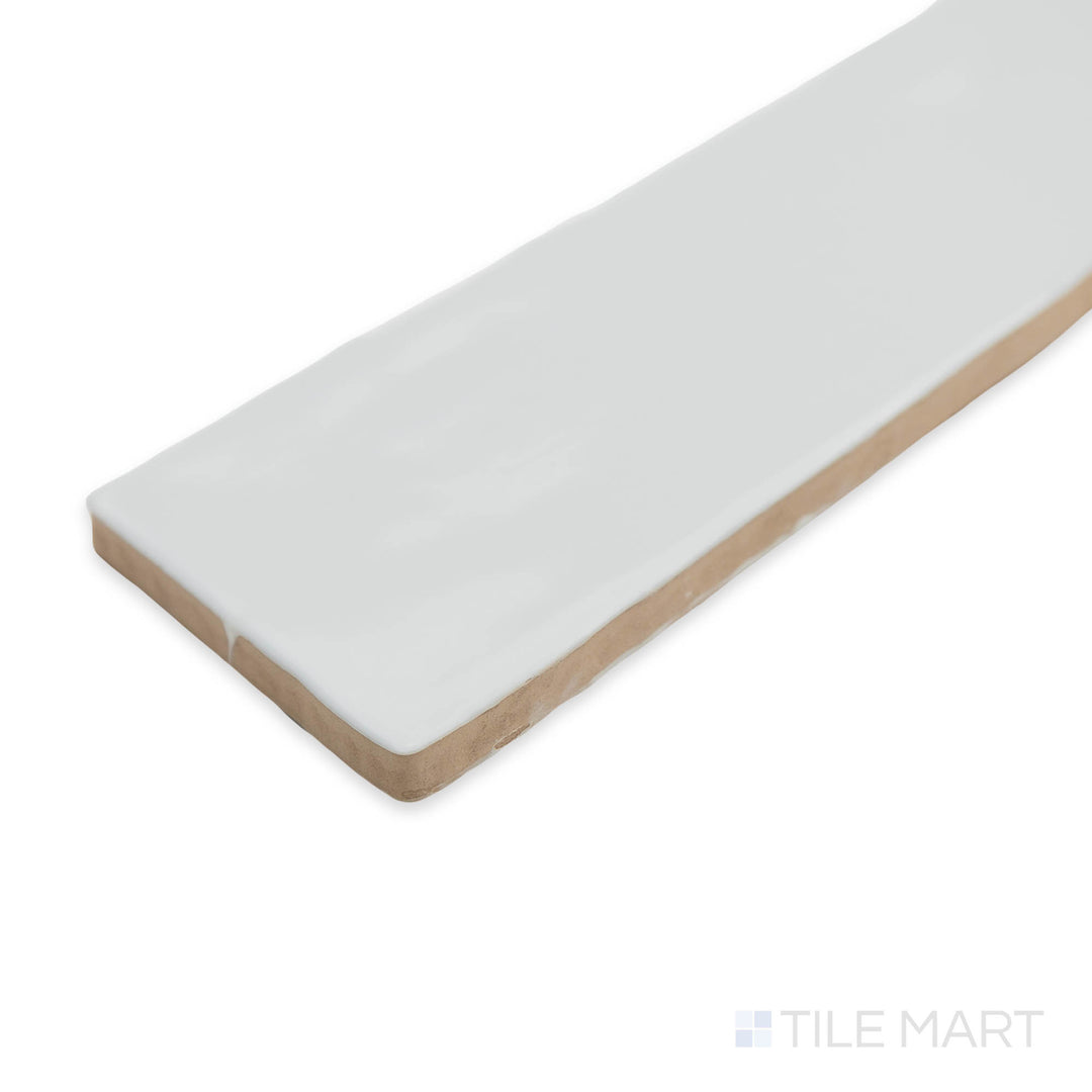 Zellige White 2x16 bright ceramic tile in a corner shot, showcasing its glossy finish and handcrafted texture for a timeless, artisanal look.