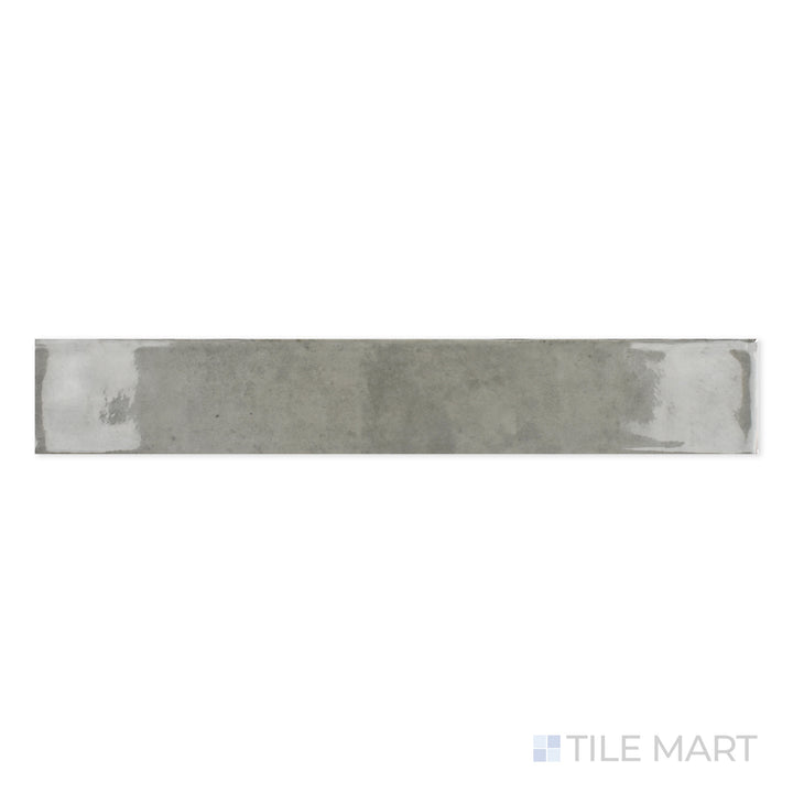 Zoomed-in view of Zellige Tender Gray 2X16 Bright Ceramic, showcasing its soft gray hue and glazed texture that enhances visual depth.