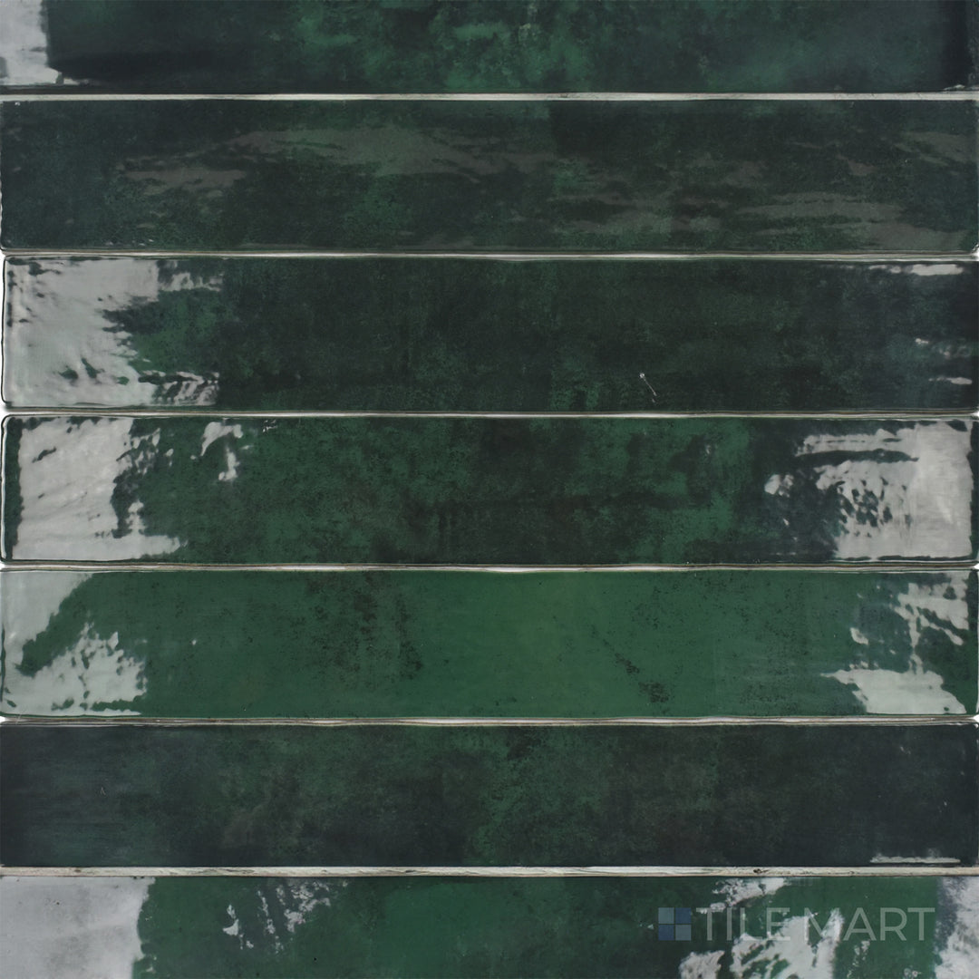 Captured from above, the Zellige Emerald Green 2x16 inch bright ceramic tile features a rich green hue and glossy sheen, adding a luxurious and nature-inspired touch.