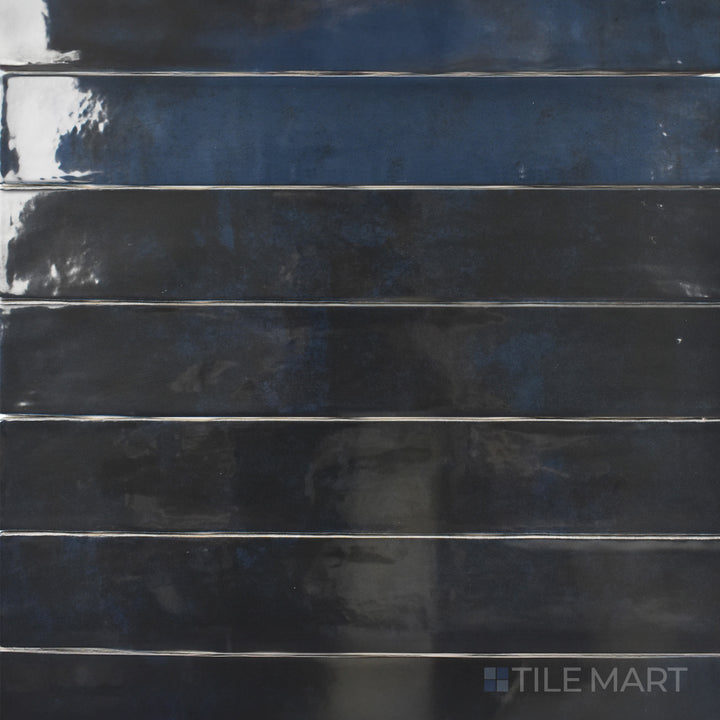 A high-angle view of the Zellige Deep Blue 2x16 inch bright ceramic tile highlights its striking deep blue shade and polished surface, perfect for a bold and sophisticated aesthetic.