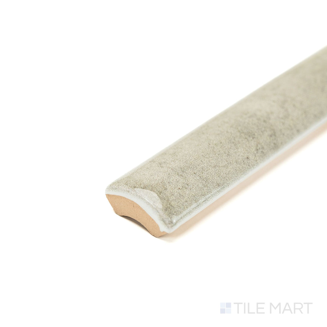 Corner angle of Zellige Tender Gray 0.75x16 Bright ceramic pencil tile, focusing on its slender form, soft gray tone, and glossy finish for edge and accent use.