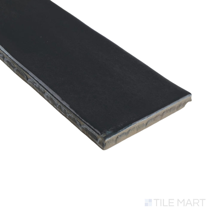 Corner shot of Granadella Carbon 2.5x9 tile highlighting its sleek edges and deep black glossy finish with subtle reflections.