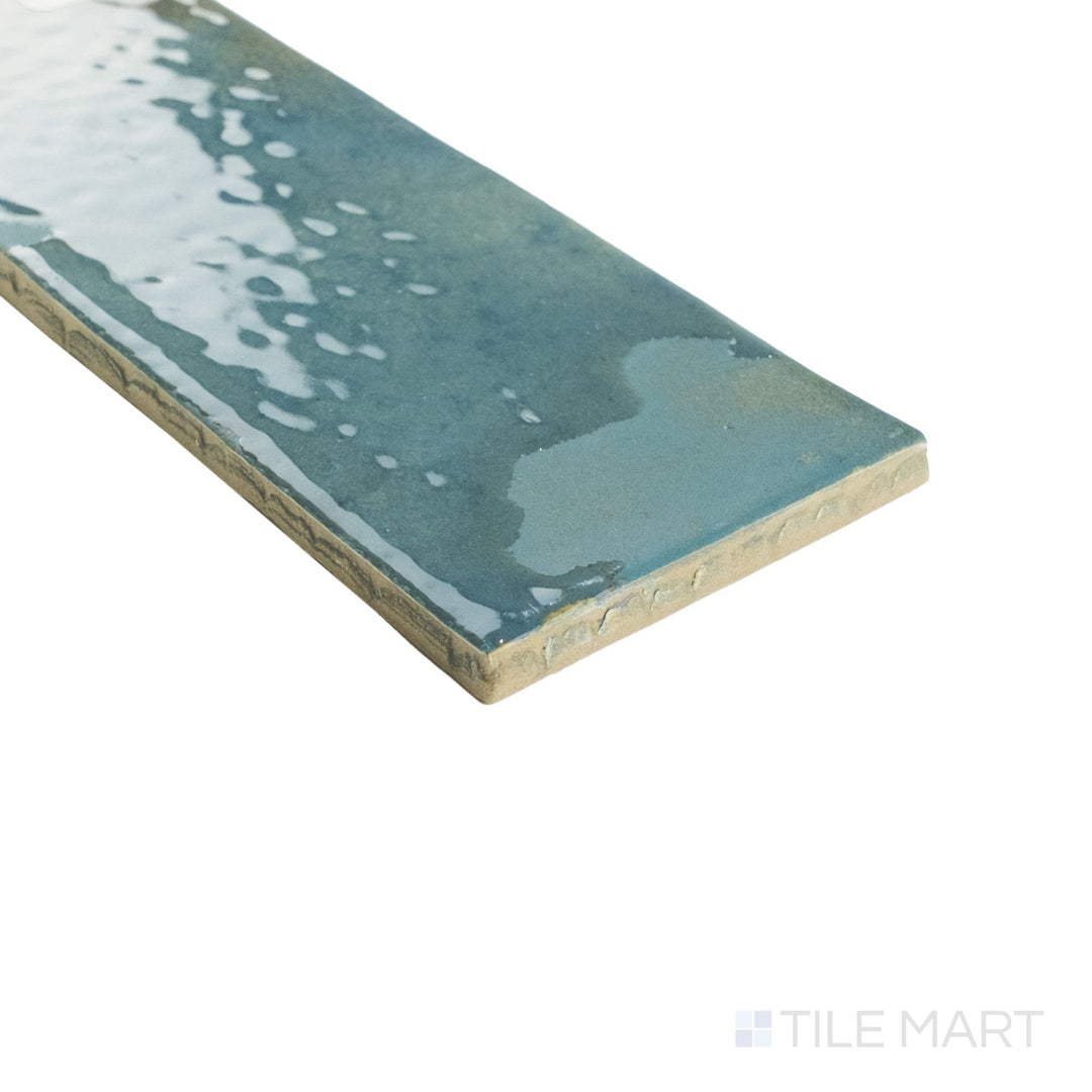 Angled corner view of Granadella Esmeralda tile showing its rich emerald glaze wrapping smoothly around crisp tile edges.