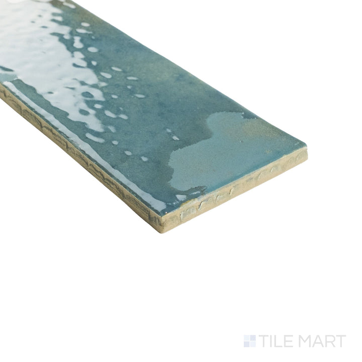 Angled corner view of Granadella Esmeralda tile showing its rich emerald glaze wrapping smoothly around crisp tile edges.