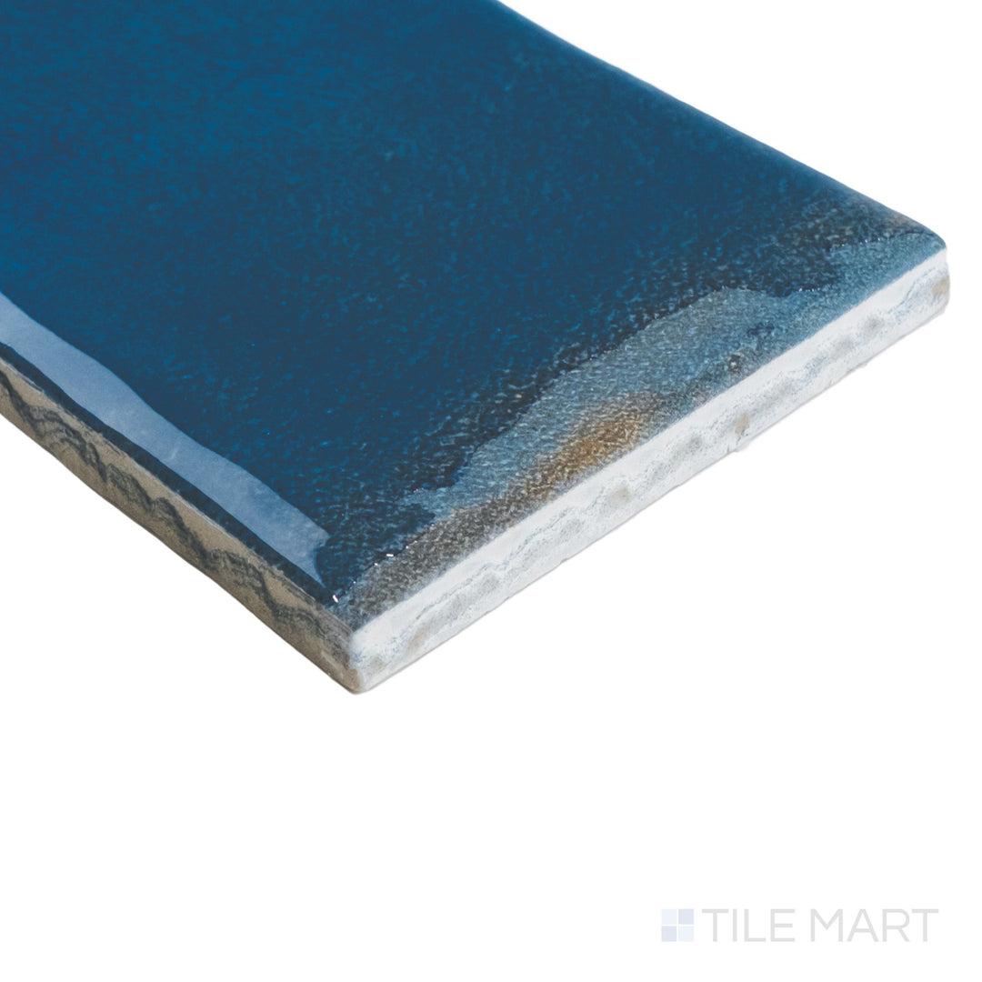 Corner perspective of Granadella Marino tile with a dark blue gloss and well-defined edge detail accentuating its elongated shape.