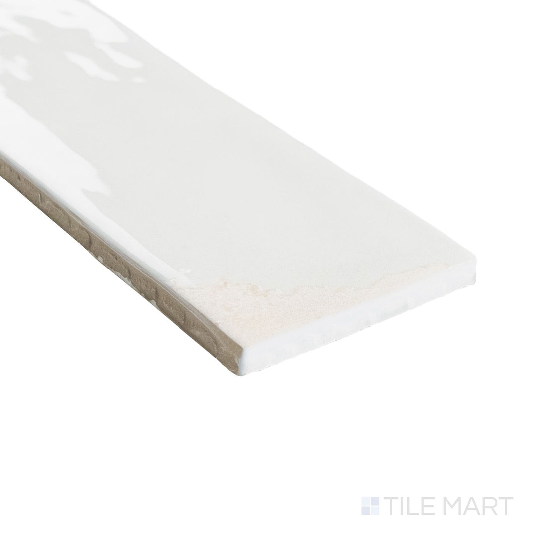 Close-up corner view of Granadella Sal 2.5x9 tile featuring soft gray tones and a high-gloss finish across its slim profile.