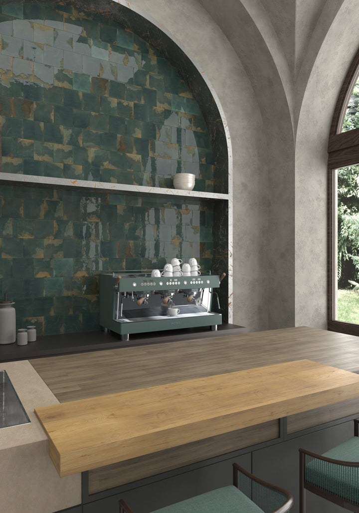 Green glossy tiles create a bold kitchen backsplash with wood accents.