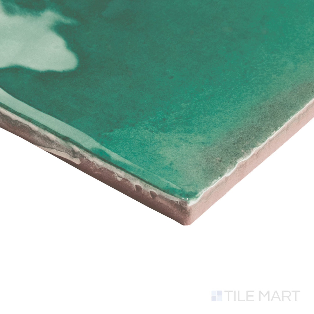Angled shot of Granadella Esmeralda 4.5x4.5 tile showing vibrant green glaze meeting precisely cut tile edges.