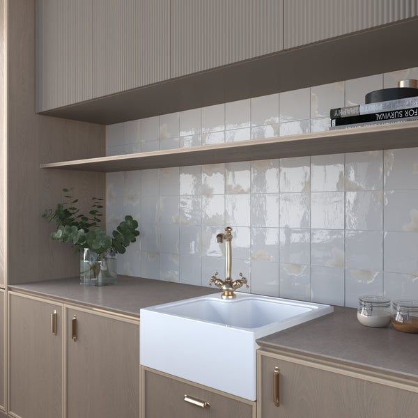 Soft grey square glossy tiles in a minimalist bathroom setting.