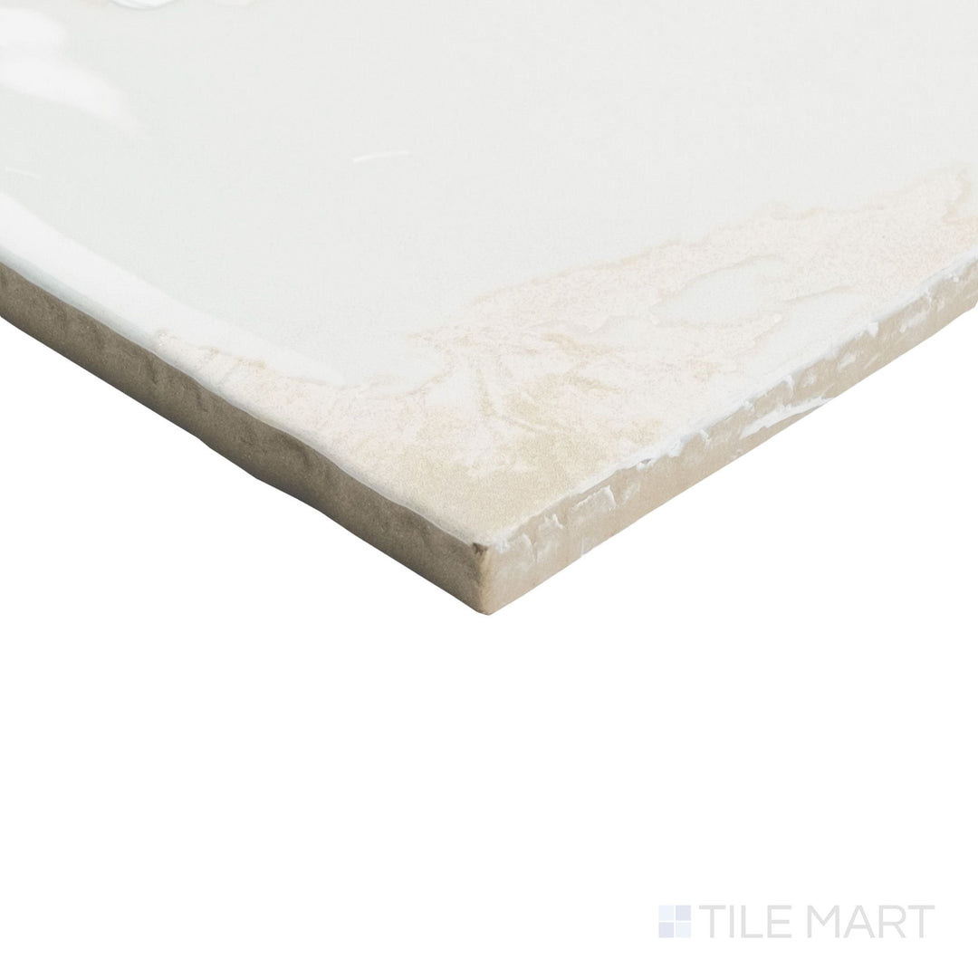 Close-up corner angle of Granadella Sal 4.5x4.5 tile highlighting its soft gray hue and polished reflective finish.