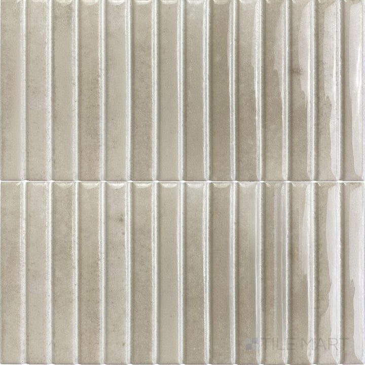 Soft ivory hues blend with a glossy surface in this Kit Kat mosaic tile, offering a warm and timeless look.