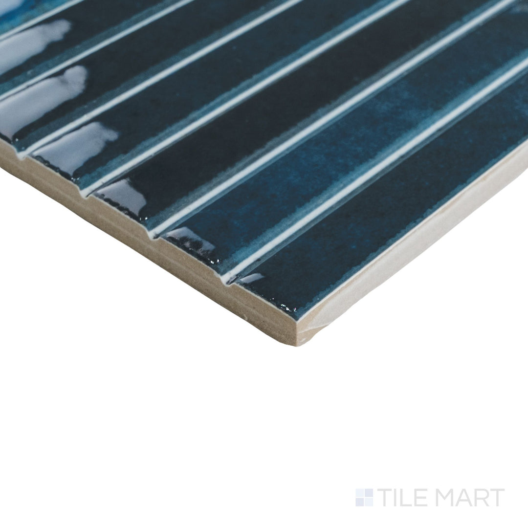 Corner perspective of Kit Kat Ocean mosaic capturing deep blue glossy sticks with precise grout lines at the edge.