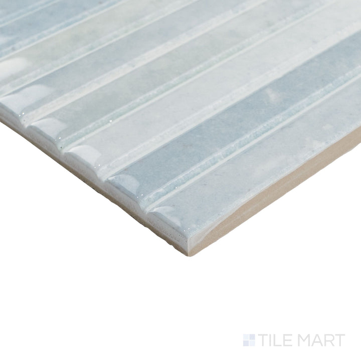 Corner view of Kit Kat Water mosaic with soft blue-green tones and a reflective surface along clean-cut edges.