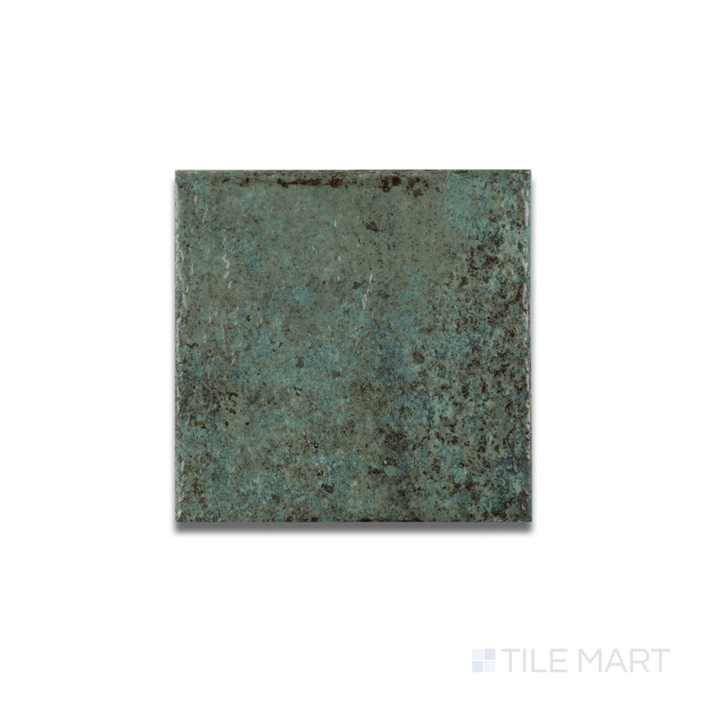 Flat lay of Tahiti Emerald glossy porcelain tile revealing a reflective finish and vibrant jewel-toned surface.