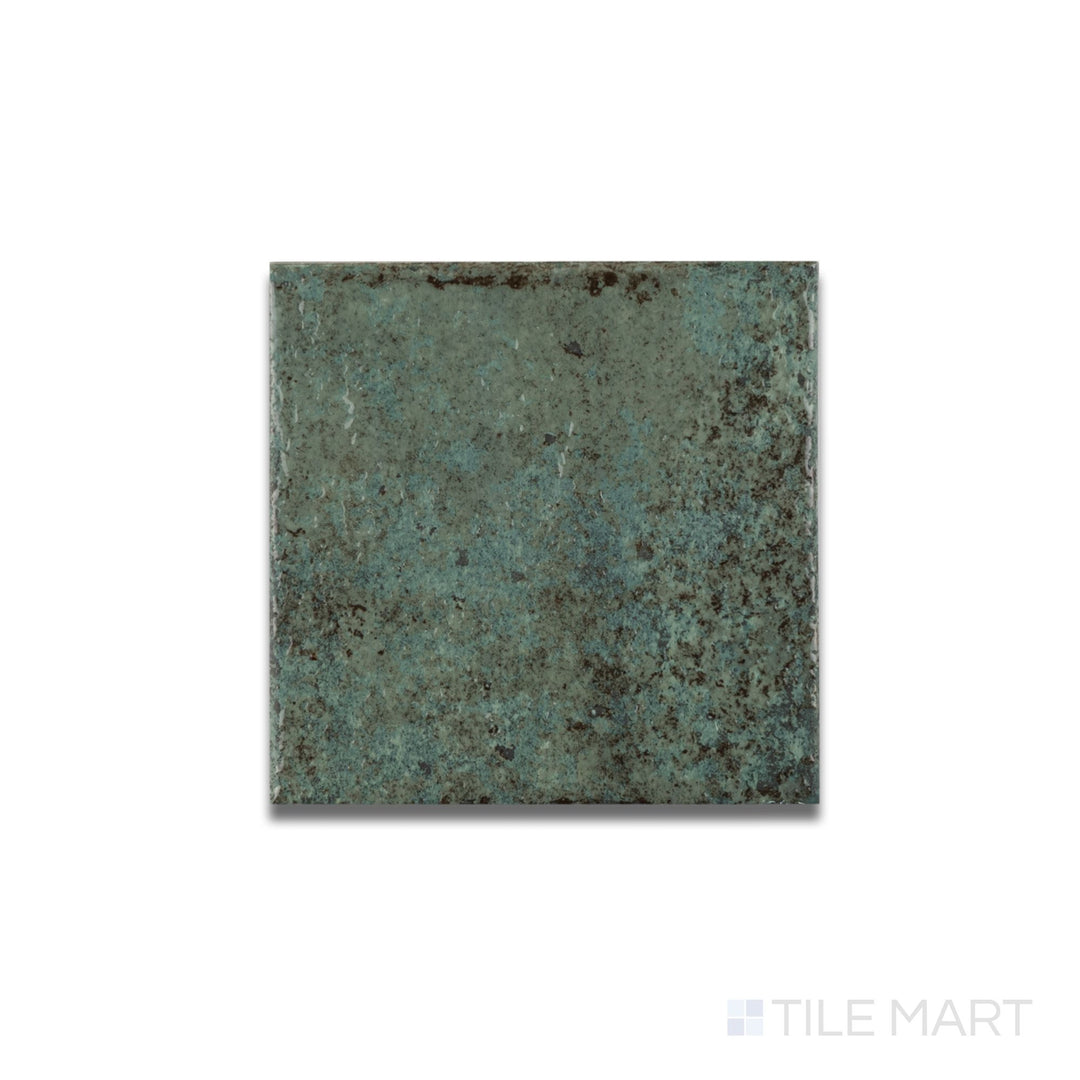 Flat lay of Tahiti Emerald glossy porcelain tile revealing a reflective finish and vibrant jewel-toned surface.