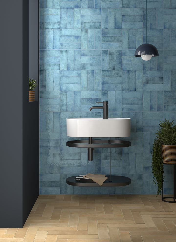 Agadir Agua 3x11 glossy porcelain tile in vivid aqua tones, creating a bright and refreshing wall feature.