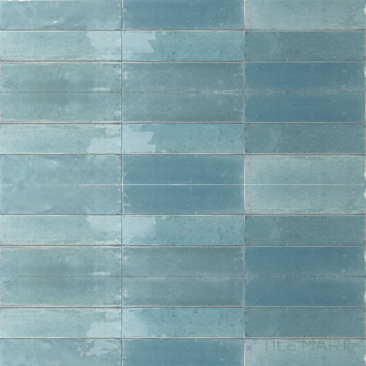 A refreshing aqua hue and glossy surface define this 3x11 Agadir Agua porcelain tile with a clean, coastal feel.