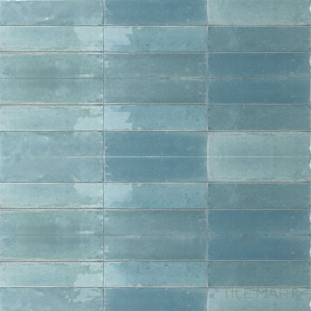 A refreshing aqua hue and glossy surface define this 3x11 Agadir Agua porcelain tile with a clean, coastal feel.